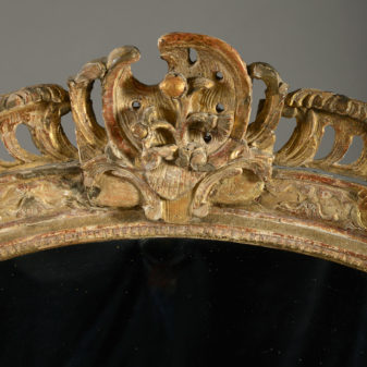 An early 18th century louis xv period giltwood mirror