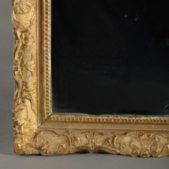 An early 18th century louis xv period giltwood mirror