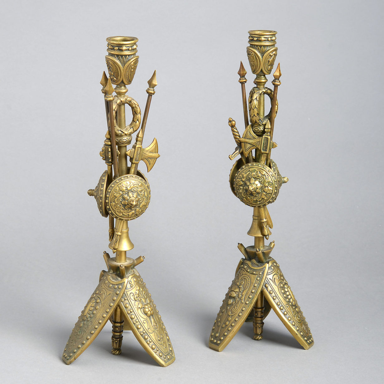 A pair of brass classical trophy candlesticks