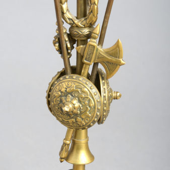 A pair of brass classical trophy candlesticks