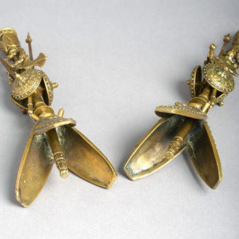 A pair of brass classical trophy candlesticks