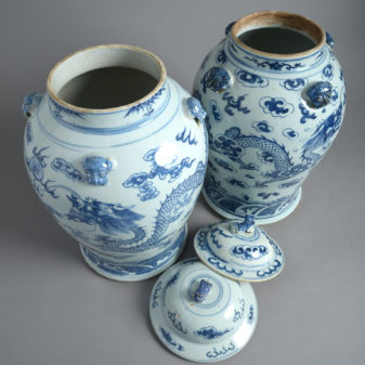 A close pair of chinese blue and white porcelain covered jars or 'temple jars'