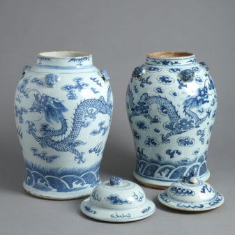 A close pair of chinese blue and white porcelain covered jars or 'temple jars'