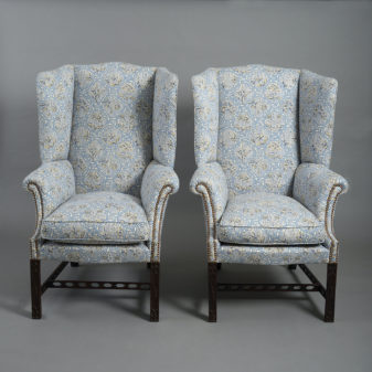 A Pair of Mahogany 'Gothic Chippendale' Wing Armchairs
