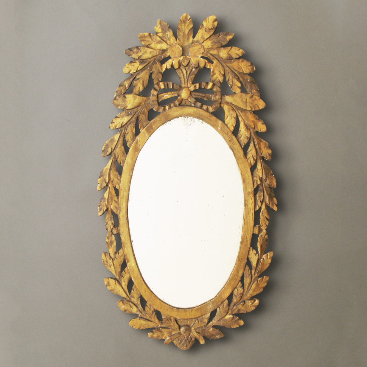 A carved oval mirror