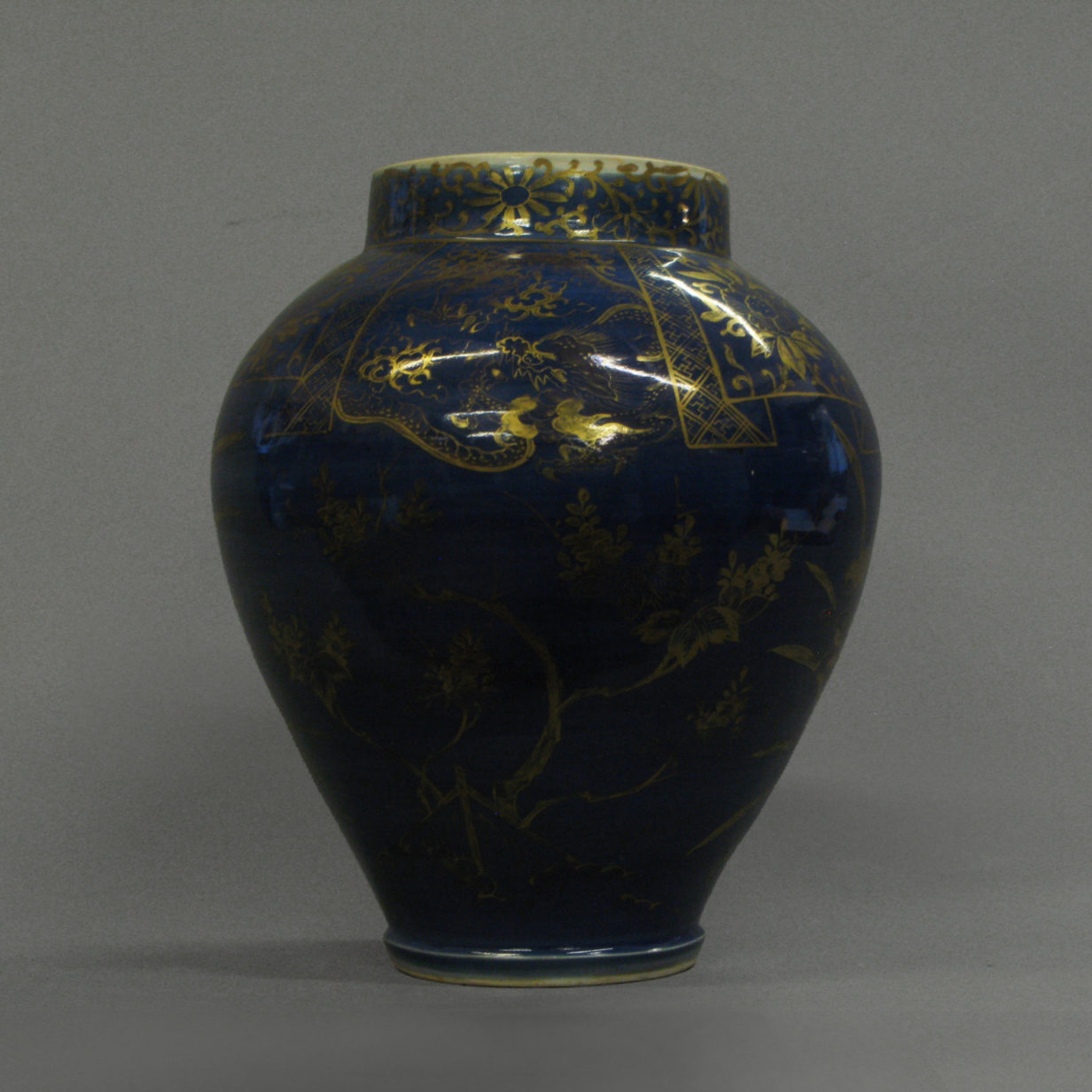 A gilded dark blue vase