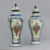 A pair of qianlong period famille rose vases & covers