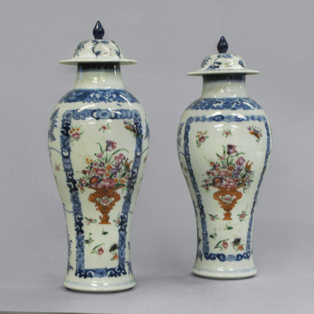 A pair of qianlong period famille rose vases & covers