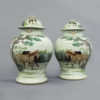 A pair of equestrian themed chinese vases and covers