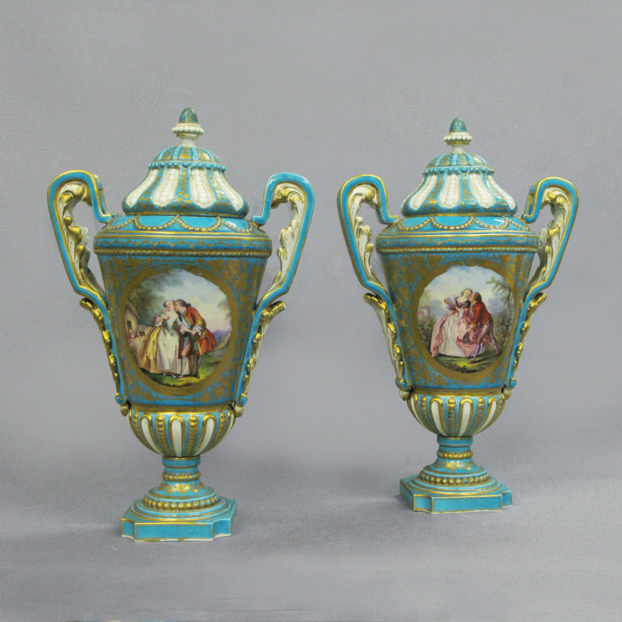 A Pair of Blue Ground Sevres Vases & Covers