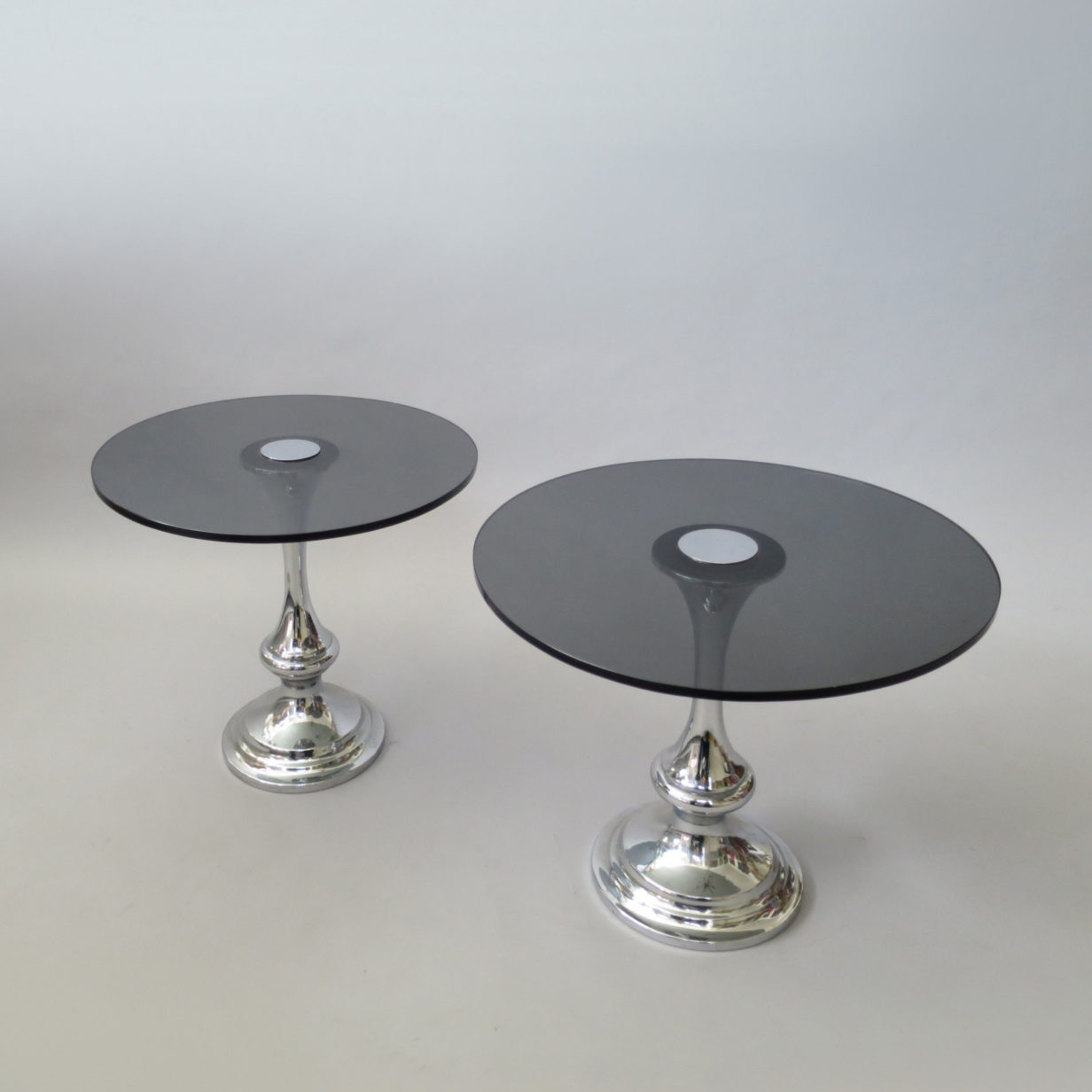 A pair of glass and chrome low tables