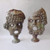 A pair of large bronze classical masks