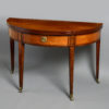 A fine 18th century inlaid demi-lune mahogany tea table