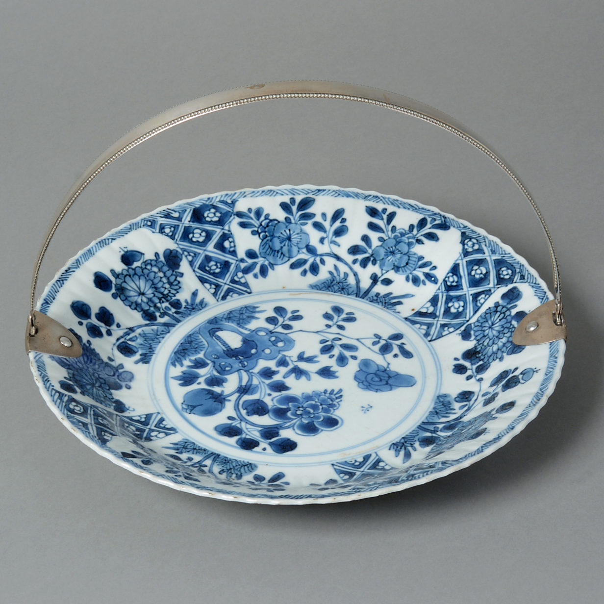 An early 18th century kangxi plate with european silver handle