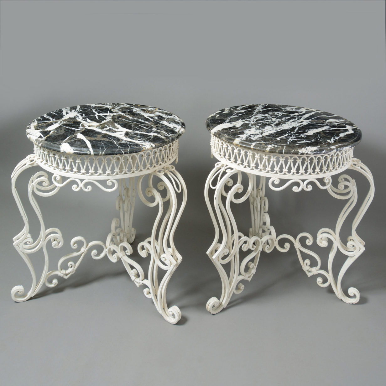 A pair of painted cast iron occasional tables