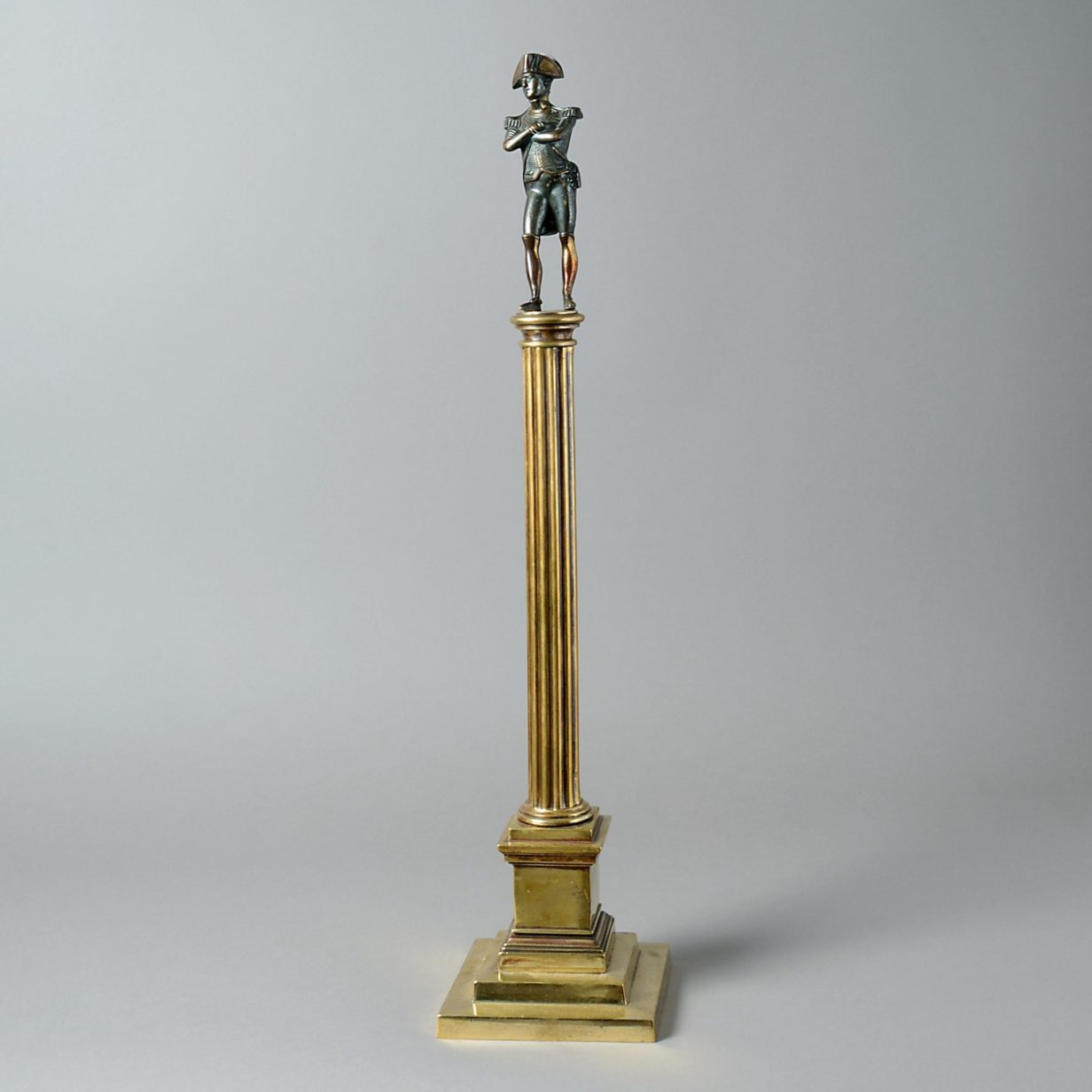 A 19th century steel statuette of napoleon set upon a brass column