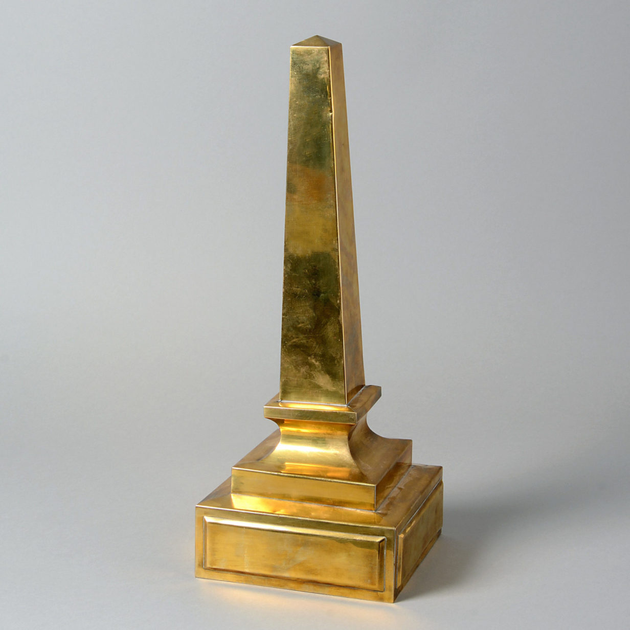 A mid-20th century brass obelisk