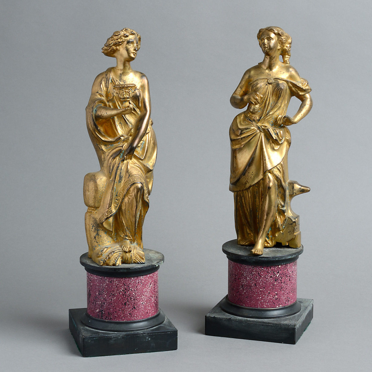 A large pair of 18th century gilt bronze figures on faux porphyry socles
