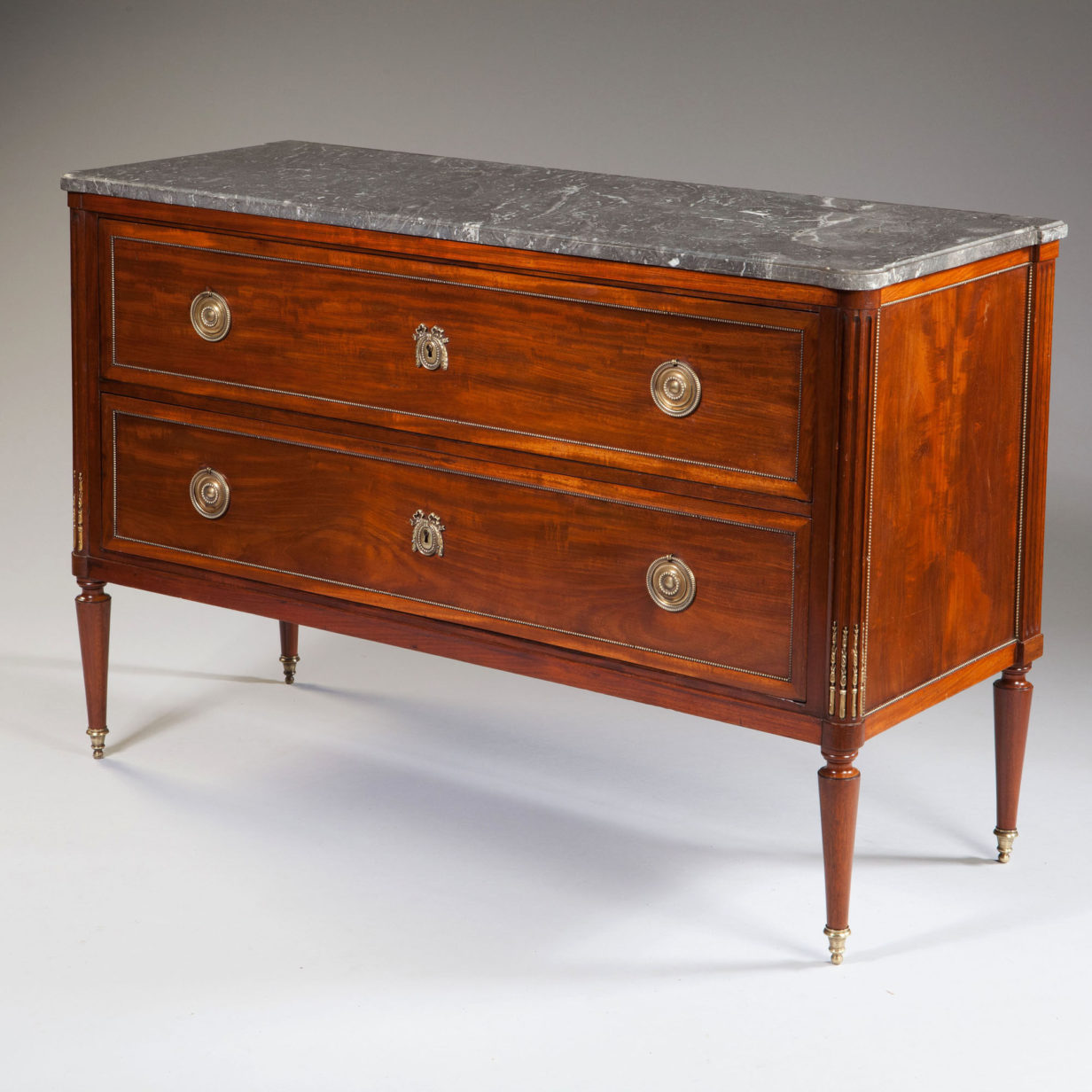 A late 18th century mahogany commode or chest of drawers