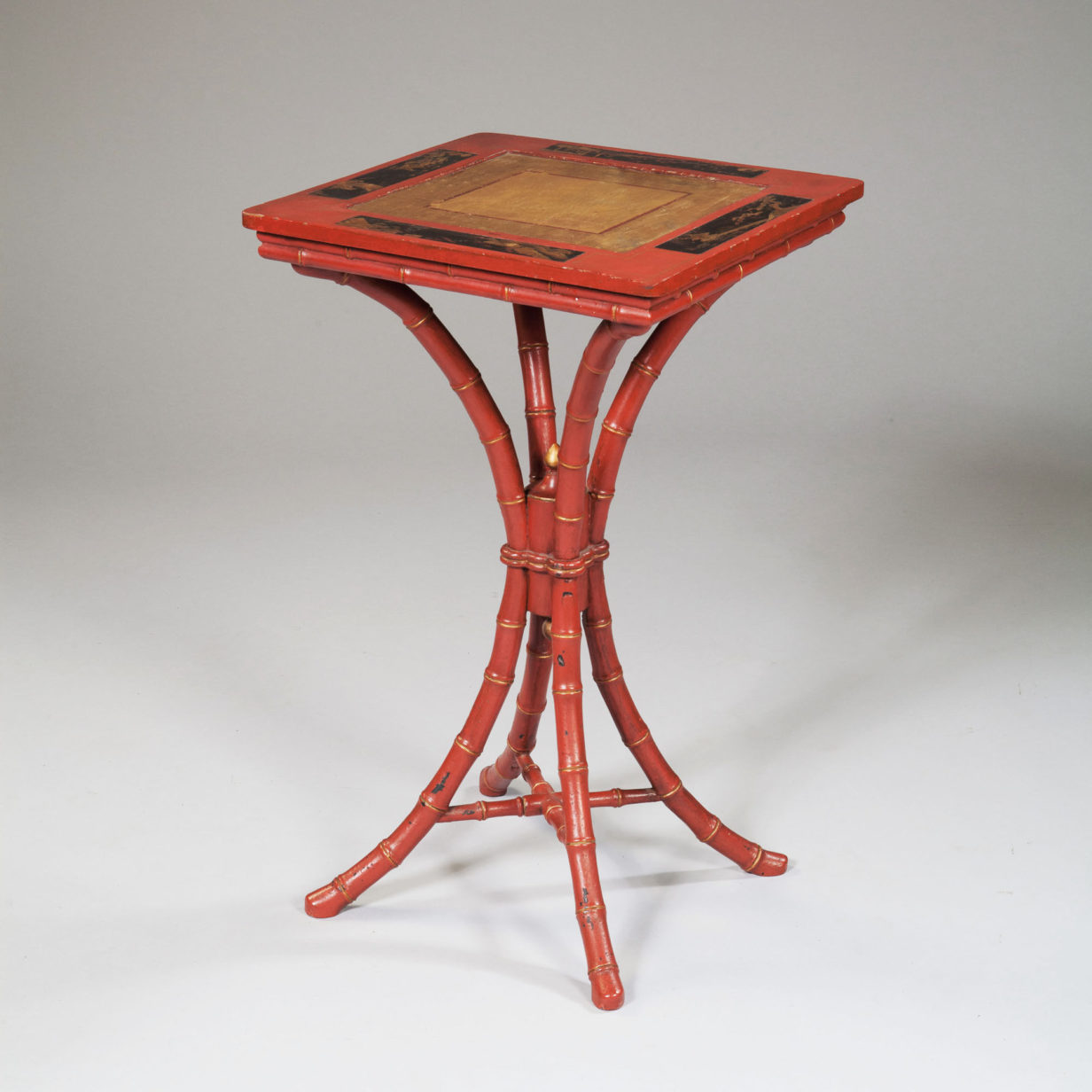 A red japanned faux bamboo occasional table
