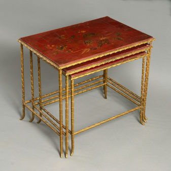 A mid-century nest of lacquer and gilt metal tables by maison baguès