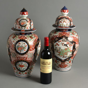 A large pair of 19th century imari vases and covers