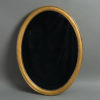A mid-19th century giltwood oval mirror