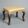 A 19th century walnut stool in the queen anne manner