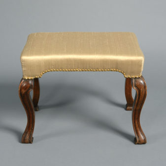 A 19th century walnut stool in the queen anne manner