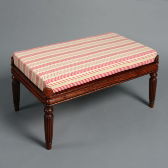 A pair of 20th century upholstered benches in the regency manner