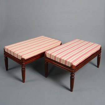 A pair of 20th century upholstered benches in the regency manner