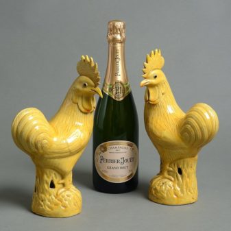 A 19th century pair of yellow glazed cockerels