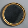 An early 19th century circular giltwood mirror