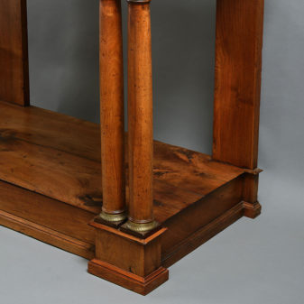 An early 19th century empire period walnut console table