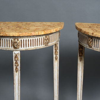 A pair of late 19th century adam style console tables