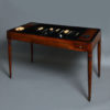 An 18th century directoire period walnut games or tric trac table