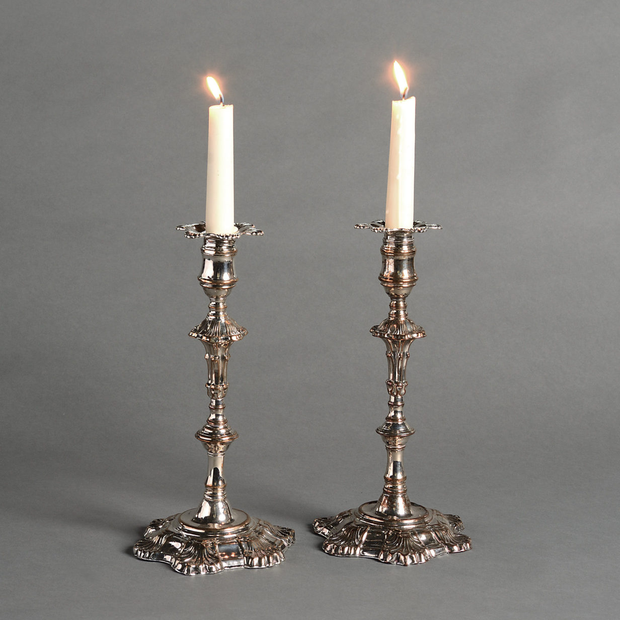 A pair of mid-18th century old sheffield plate candlesticks