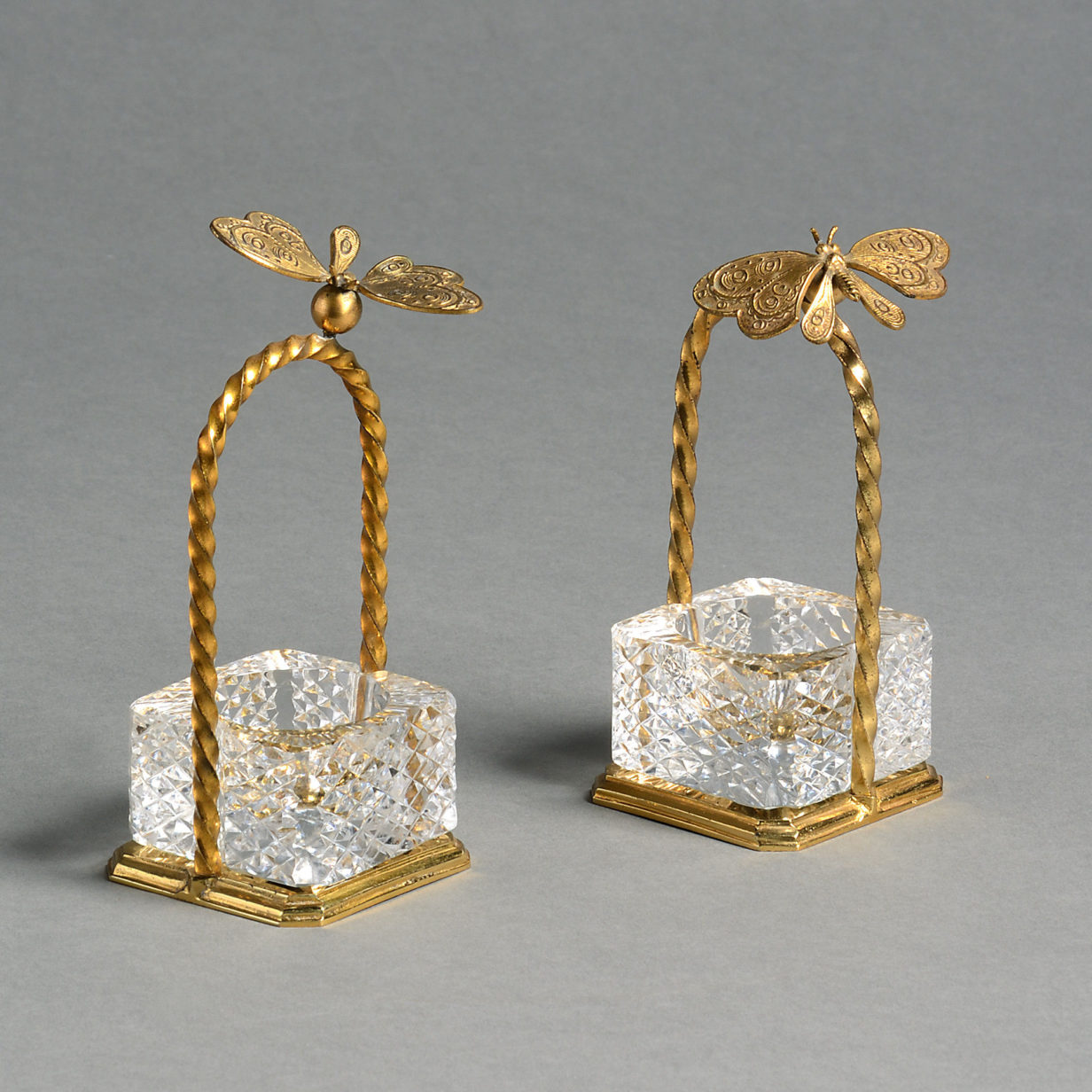 A pair of mid-20th century ormolu and cut glass salts