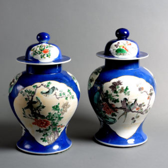 A pair of 19th century qing dynasty famille verte vases & covers