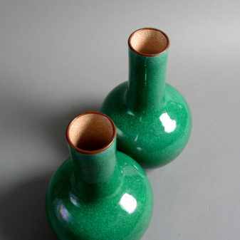 A pair of 19th century qing dynasty green ground porcelain bottle vases