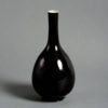 A 19th century black glazed porcelain bottle vase