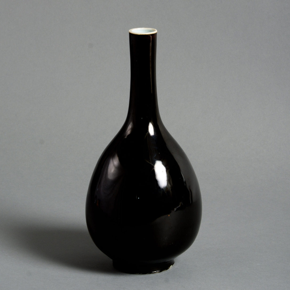 A 19th century black glazed porcelain bottle vase