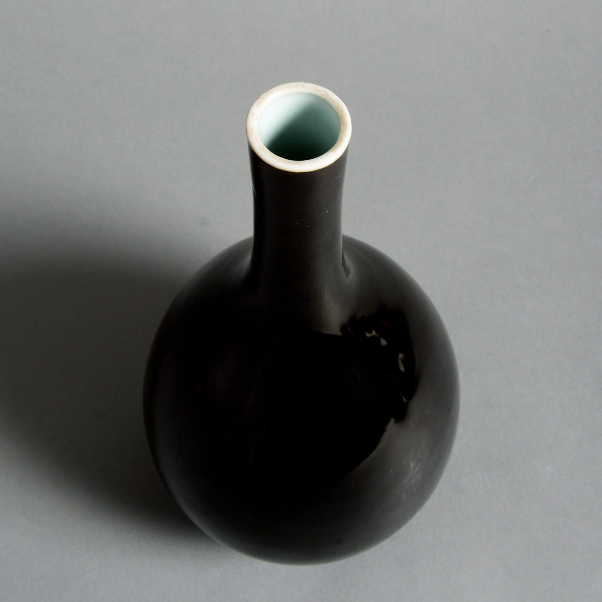 A 19th century black glazed porcelain bottle vase