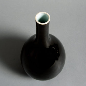 A 19th century black glazed porcelain bottle vase