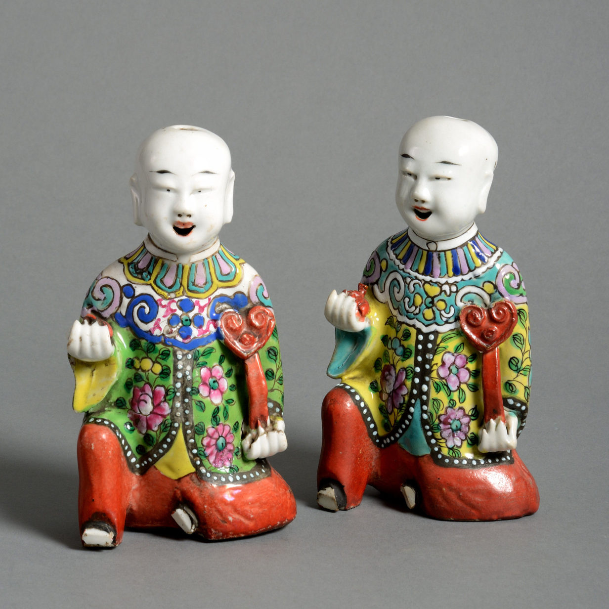 A pair of early 19th century porcelain laughing boys