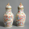 A 19th century pair of chinese canton vases and covers
