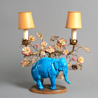 A pair of late 19th century porcelain & ormolu elephant candelabra