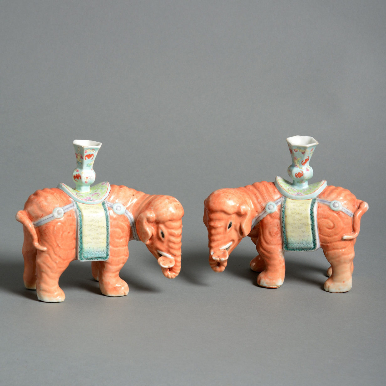 A pair of porcelain elephant candle holders