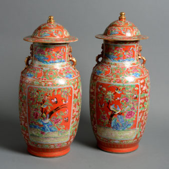 A pair of 19th century orange glazed vases