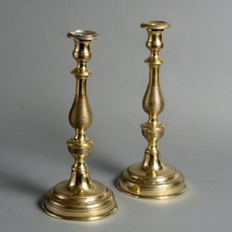 A set of four 19th century large brass candlesticks